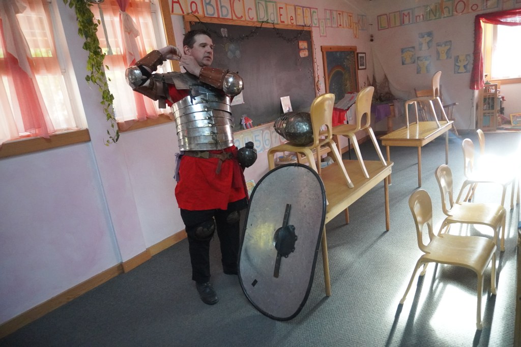 Ben Ward is putting on his final piece of armor in a classroom at Siskiyou School in Ashland, OregonApril 16, 2026