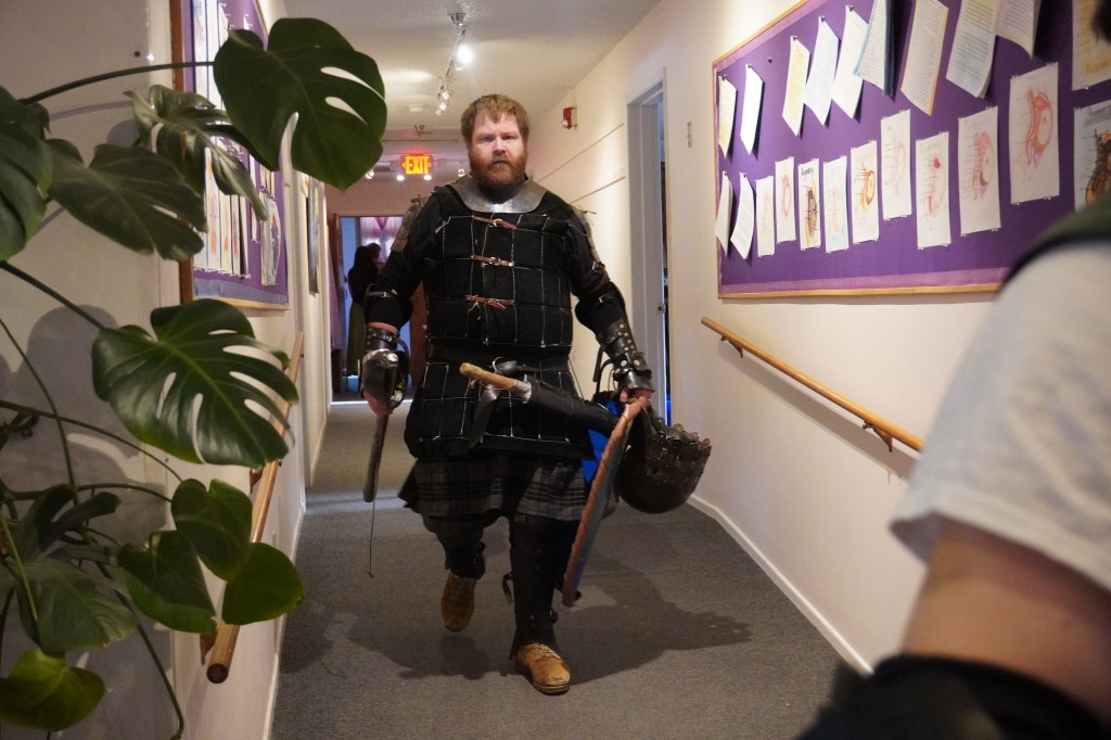 John Latson marches to battle down a school hallway in Ashland, Oregon. April 16, 2026.