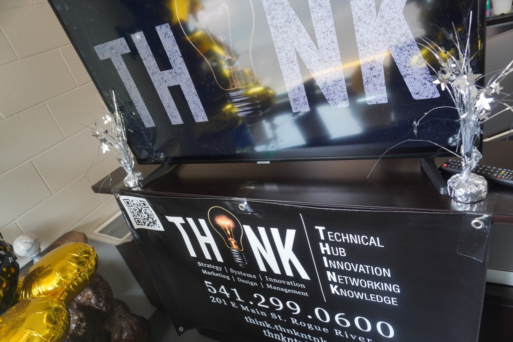 Picture of a promotional sign for THINK taken just inside their front window